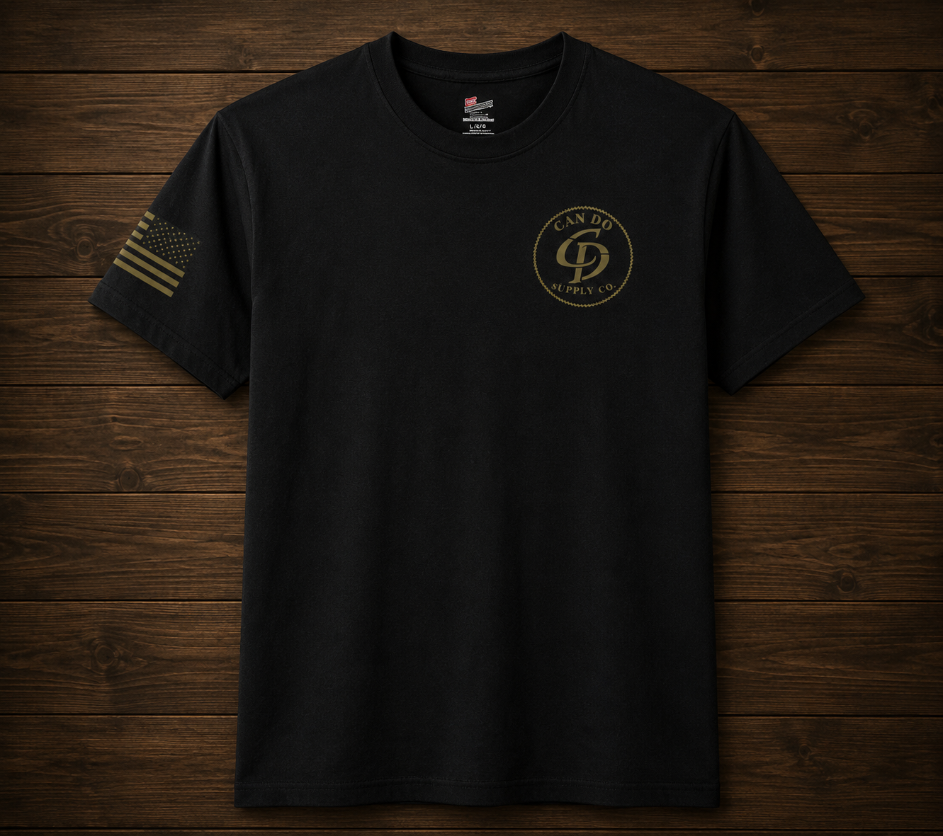 Black t-shirt with a logo and text on a wooden surface
